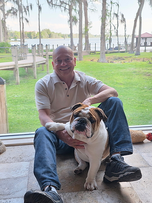 Author Alex Lucio with Baloo, the English bulldog whose namesake anchors the novel The Weight of a Dog.