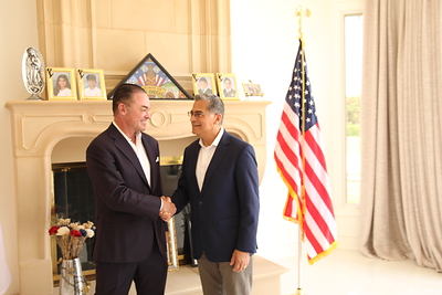 Attorney John Gomez shakes Becerra's hand welcoming him to San Diego. 