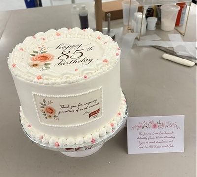Sara Lee Frozen Bakery Product Developers David Meza, Senior Food Scientist; Adam Hegadorn, Senior Food Scientist; and Becky Sowa, Manager, Technical Services, designed Sara Lee's 85th Birthday cake. The team surprised Sara Lee with a layered creation of Sara Lee pound cake, cheesecake, and strawberries, which they affectionately named the “Cheesecaken," and decorated it with a personalized message.