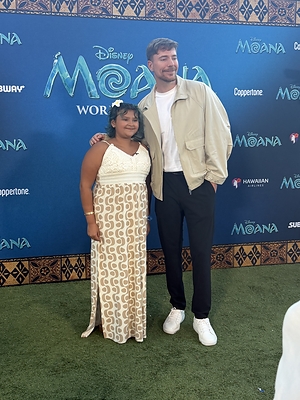 Abby poses with Mr. Beast during the Moana world premiere, made possible through a special collaboration between Little Smiles and Mr. Beast to create unforgettable experiences for children facing serious illness and adversity.