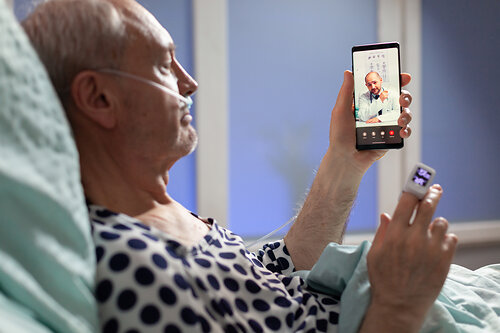 Patient getting an on-demand psychiatric consult from his hospital bed. Patient getting an on-demand psychiatric consult from his hospital bed.