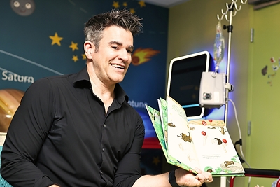 Jeff Civillico reads aloud during a Win Win Charity visit to a partner children's hospital. The Las Vegas-based nonprofit arranges in-person and virtual visits from professional entertainers, athletes, and celebrities at more than 100 children's hospitals nationwide. *Photo courtesy of University Medical Center