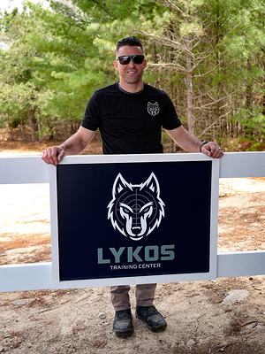 Lykos Training Center Founder Yanni Vasvatekis presents the facility’s new official branding, reinforcing the center’s commitment to premium tactical training in Massachusetts.