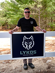 Lykos Training Center Founder Yanni Vasvatekis presents the facility’s new official branding, reinforcing the center’s commitment to premium tactical training in Massachusetts.