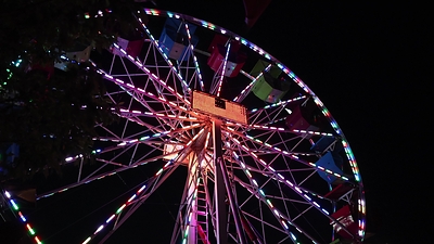 A 65-foot Ferris wheel overlooking Georgian Bay, lights up the night sky at the Memories of Summer festival.
