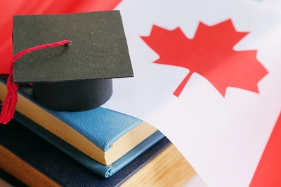 Canada Flag with books and Mortar Board. NACC & Oxford International Digital Institute join forces. 