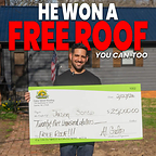 Winner of the 2025 Gator Metal Roofing Sweepstakes in front of his new Glossy Black Metal Roof holding his winnings.