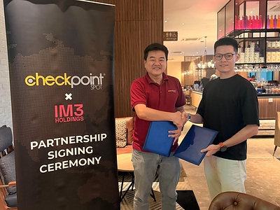 Benjamin Yeow (left), Chief Executive Officer of CheckPointSpot Pte. Ltd., and Phyo Myint Han (right), Managing Director of IM3 Holdings Co., Ltd., exchange partnership agreements following the signing of an exclusive strategic partnership to introduce CheckPointSpot's integrated race technology ecosystem to Myanmar.