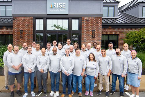 The RISE Commercial District team celebrates the company’s No. 854 ranking on the 2026 Inc. 5000 outside its Indianapolis headquarters.