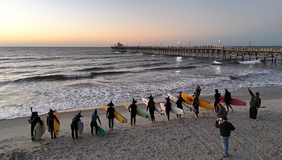 This fall, costumed surfers with black hats and broomsticks will paddle into the Atlantic for the fifth annual Witches Sunrise Surf in North Myrtle Beach. The event has become one of the area's most delightfully unexpected Halloween traditions. Credit: Visit Myrtle Beach