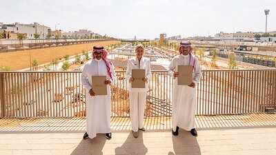 Jayne McGivern, CEO of the Sports Boulevard Foundation (center) with officials from Rikaz Properties and Al Jazira Capital. This image opens in the lightbox