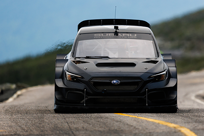 Heat waves billow out from Project Midnight as Scott Speed powers his way to the summit of Mt. Washington