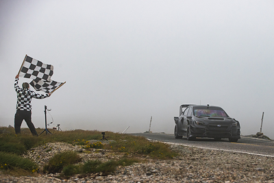 Scott Speed and Project Midnight cross the finish line at the summit of Mt. Washington in a thick fog