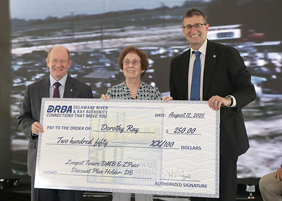 US Senator Chris Coons and Delaware Governor Matt Meyer show appreciation to Ms. Dorothy Ray for her status as the longest tenured Delaware Memorial Bridge E-ZPass Discount Plan holder from Delaware
