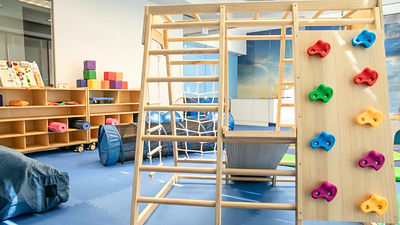 Climbing Wall in Behavior Frontiers' ABA Therapy Center Gross Motor Room for Developing Movement Skills in Kids with Autism Climbing Wall in Behavior Frontiers' ABA Therapy Center Gross Motor Room for Developing Movement Skills in Kids with Autism