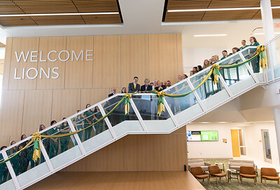MSSU students line the grand staircase of the Roy Blunt Health Science Innovation Center as the ribbon is cut, officially marking the opening of the new facility.