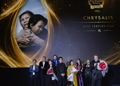 Members of the Chrysalis team celebrate the film's Best Feature Film honor at the 2026 Los Angeles Tribune International Film Festival. From left: Tien Pham, Leo Ortega, Sharla Ortega, composer Elia Cmiral, Sir Daniel K. Winn, Kieu Chinh, Valerie Vu, Peter Vu and Randall J. Slavin.