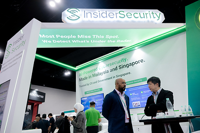 A visitor engages in conversation at the InsiderSecurity booth in 2025. Visitors can expect to see them once again at CyberDSA 2026