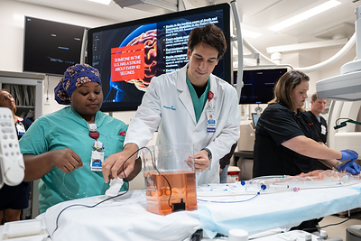 Dr. Guilherme Agnoletto shows the thrombectomy p AdventHealth Wesley Chapel CEO Ryan Quattlebaum 