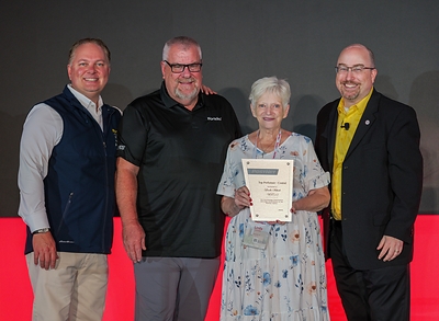 PostNet's Central Region Center of the Year winner for 2026 is its Draper, Utah location owned by Linda Schiele, who was honored at the company's annual conference in Chattanooga, Tenn. in July 2026. Pictured (from left) are Chief Commercial Officer and Country Manager Jon Visser, Business Development Coach Brad Berger, Schiele, and Senior Business Development Coach Gene Cummings.