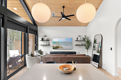 Vaulted pine ceilings and a wall of glass in the main living space at Inkwell Manor.