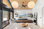 Vaulted pine ceilings and a wall of glass in the main living space at Inkwell Manor.