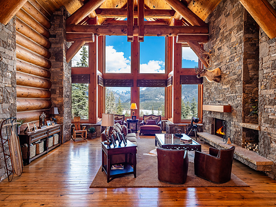 A two-story, grand salon sits at the heart of the main residence, offering beautiful views of Electra Lake and the surrounding San Juan Mountains. The cathedral ceilings feature tongue-and-groove cedar with Douglas fir cross beams, accented by solid fir baseboard molding. DurangoLuxuryAuction.com.