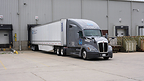 A modern Quality Wheels Inc. dry van truck positioned at a loading dock, ready for FTL freight dispatch.