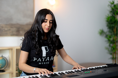 Payam Music teacher playing piano.