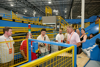 Guests tour the newly commissioned double-deck cross-belt sorter at GOFO's Dallas Central Primary Hub on Aug. 21, 2026. (Photo: GOFO)