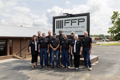 FreeFab Pallet leadership stands outside the company’s Centerville facility.