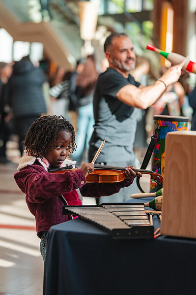 A young patron at the Long and McQuade Instrument Discovery Zone, October 2025 (Photo by Christina DeMelo/Courtesy of the Toronto Symphony Orchestra)