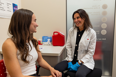 Pharmacist and patient vaccine consultation.