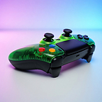 Duke Prime CWE clear green PS5 controller shown at an angled front view, featuring transparent fluorescent-green styling, colorful ABXY-style face buttons and textured Performance Grip.