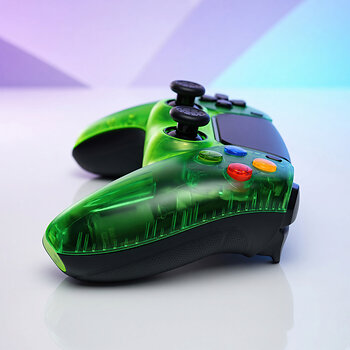 Close-up of the Killscreen Duke Prime CWE, highlighting its transparent green Xbox-inspired design, colorful ABXY-style buttons and black Performance Grip on a custom PS5 controller.