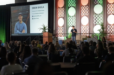Event Founder and Verdical Group CEO Drew Shula presents opening remarks to 1,000 sustainability and AEC professionals at the 2025 Net Zero Conference.  Photo Credit: Ling Luo.