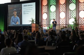 Event Founder and Verdical Group CEO Drew Shula presents opening remarks to 1,000 sustainability and AEC professionals at the 2025 Net Zero Conference.  Photo Credit: Ling Luo.