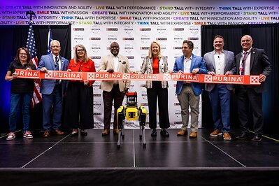 Purina leaders and local employees are joined by Spot, a robot dog designed by Boston Dynamics, for a ribbon ‘tugging’ to celebrate the grand opening of the company’s new dry pet food factory in Ohio on August 31, 2026. 