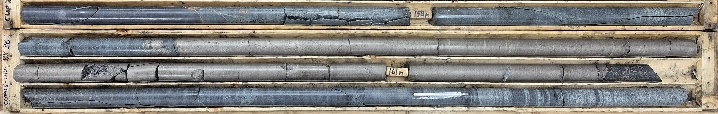 Figure 1: Photograph of the 2.45 meters thick chalcopyrite-bearing massive sulphide horizon 80-85 degrees to core axis located at the base of a sulphide bearing (blebs and disseminations) olivine pyroxenite. From 159.1 to 161.55 meters in hole CUP26-010. Figure 1: Photograph of the 2.45 meters thick chalcopyrite-bearing massive sulphide horizon 80-85 degrees to core axis located at the base of a sulphide bearing (blebs and disseminations) olivine pyroxenite. From 159.1 to 161.55 meters in hole CUP26-010.