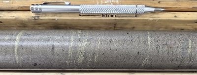 Figure 2: Close-up Photograph of the massive sulphides with chalcopyrite concentrated in1 to 3 mm bands parallel to the contacts at 80-85 degrees to core axis on average.  Center of photograph is at 159.7 meters in hole CUP26-010. The small black spots in the massive sulphides are magnetite; the pyrrhotite is not magnetic.