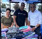 Agallas Cares volunteers distribute hundreds of filled bookbags to NYC students at the organization's annual school supply giveaway.