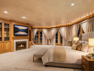 The sumptuous primary bedroom also has a private fireplace, custom built-ins and cashmere carpeting, plus oversized windows and French doors opening to the outdoor terrace. There are also two, oversized walk-in closets (not pictured). IdahoLuxuryAuction.com.