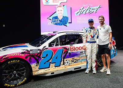 Twelve-year-old Palmer Goforth stands with William Byron in front of the special No. 24 Valvoline Chevrolet paint scheme designed by Goforth. A blood cancer survivor, Goforth’s design encourages joy and to “stay strong” while showcasing his “Miami vibes." Learn more about the collaboration between Valvoline Global, Blood Cancer United and Hendrick Motorsports at DrivingforaDream.com