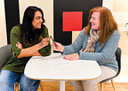 Robbie Adair, CEO of OS Training LLC, and Vinitra Swamy, CEO of Scholé AI, sign partnership agreement.