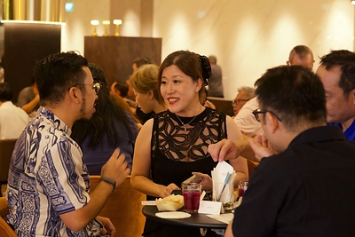 Guests mingling in the stylish venue with welcome drinks in hand at Bold Thai