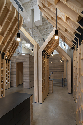 Rammed-earth architecture and repeating olive-tree-inspired wooden forms define OLIVE TREE PEOPLE’s first U.S. flagship on Abbot Kinney, translating the brand’s “From Tree to Beauty” philosophy into physical form.