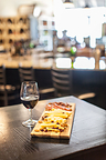 Glass of wine with cheese pairing on charcuterie board
