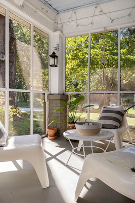 The screened front porch at 5280 Moore Street in Stone Mountain, Georgia, identifying feature of the home's appearance in Netflix's Stranger Things. Photo: Daniel Stabler, Quiet Street Photography.