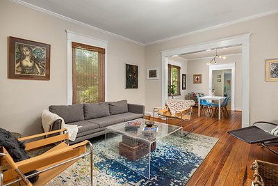 The living room at 5280 Moore Street in Stone Mountain, Georgia, with its original fireplace and a view through to the dining room. Photo: Daniel Stabler, Quiet Street Photography.
