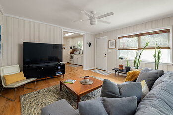 The living room at 5280 Moore Street in Stone Mountain, Georgia, opening to the kitchen. Photo: Daniel Stabler, Quiet Street Photography.